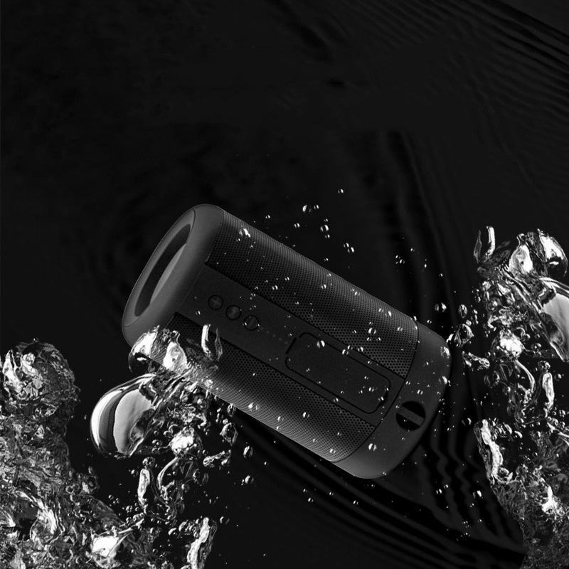 Axendris portable wireless Bluetooth speaker in black, featuring a rugged waterproof design splashing in water.
